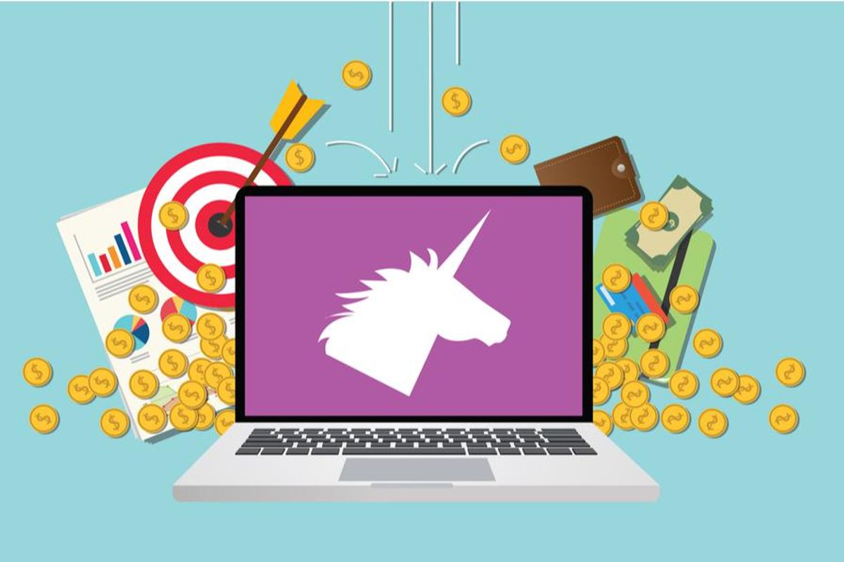 Laptop displaying unicorn silhouette.