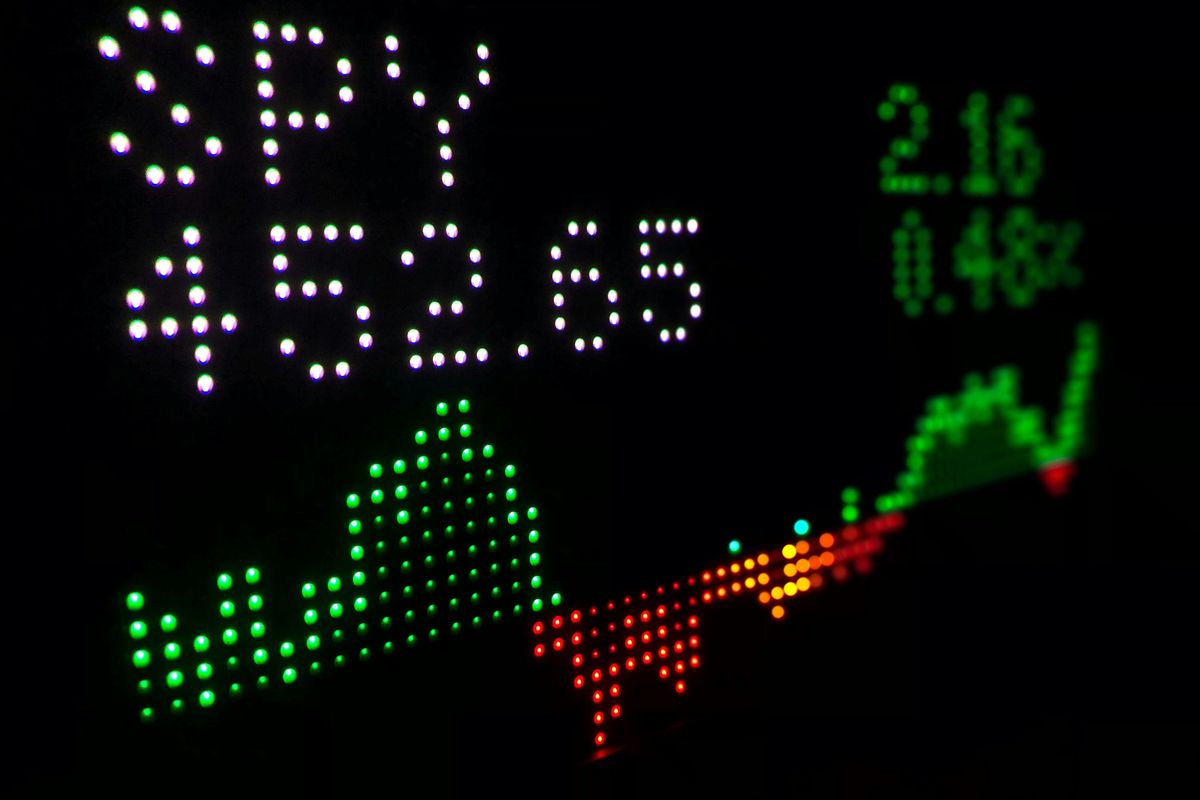 LED stock display with green graph and numbers.