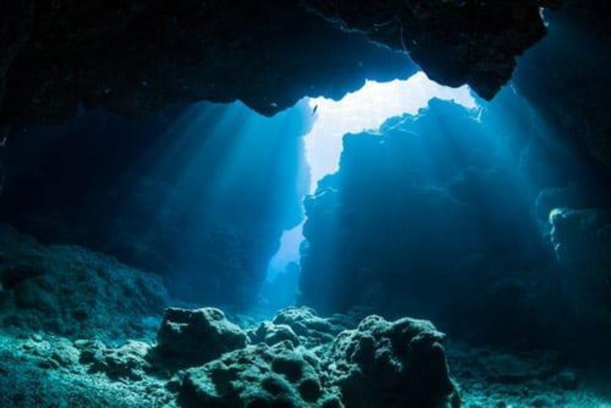 Light filtering into underwater cavern.