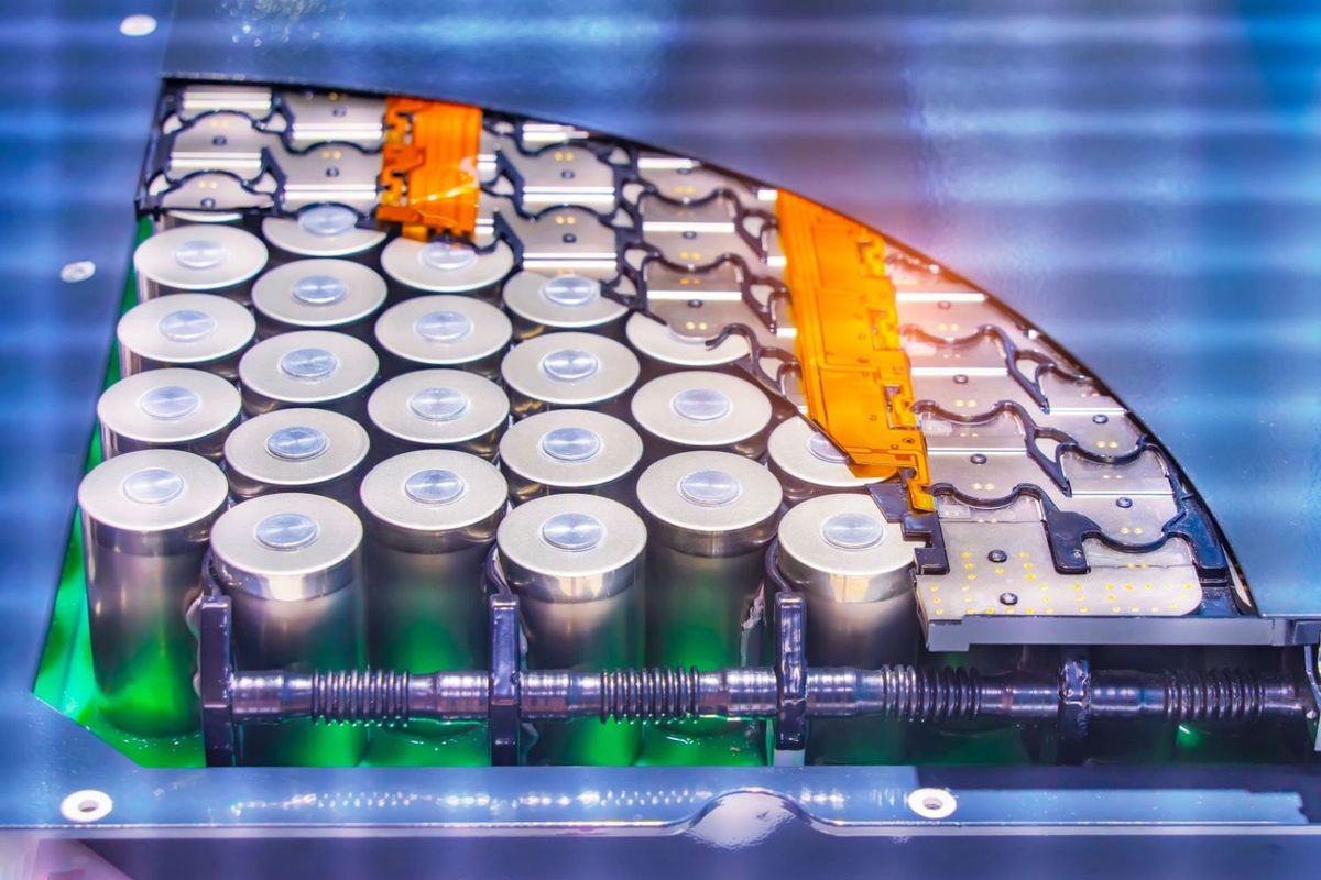 Lithium-ion battery pack with open cover so battery cells are visible.