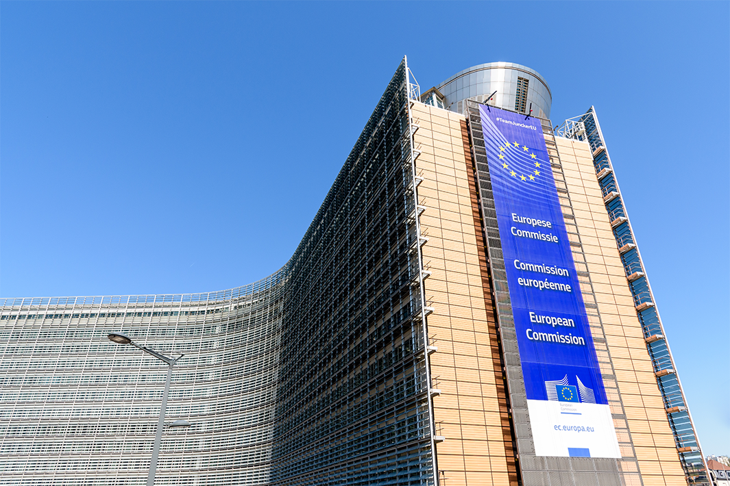 Low-angle view of European Commission banner hanging on the southern wing of the Berlaymont building.