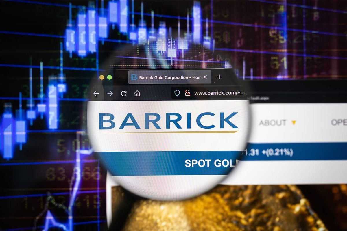 Magnifying glass over Barrick Mining website with stock chart background.