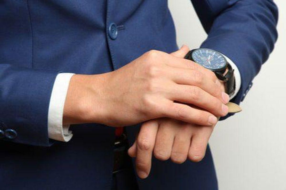 man adjusting watch