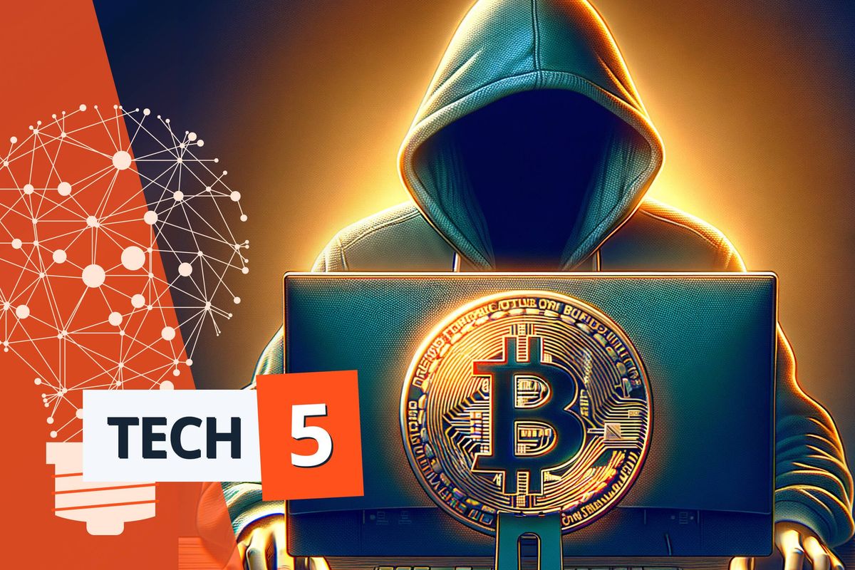 man in hoodie in front of laptop with bitcoin symbol