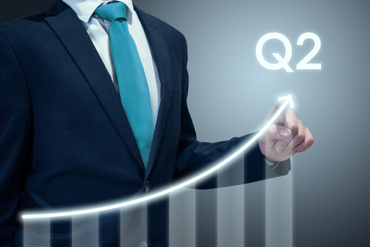 Man with ascending graph with "Q2" above it.