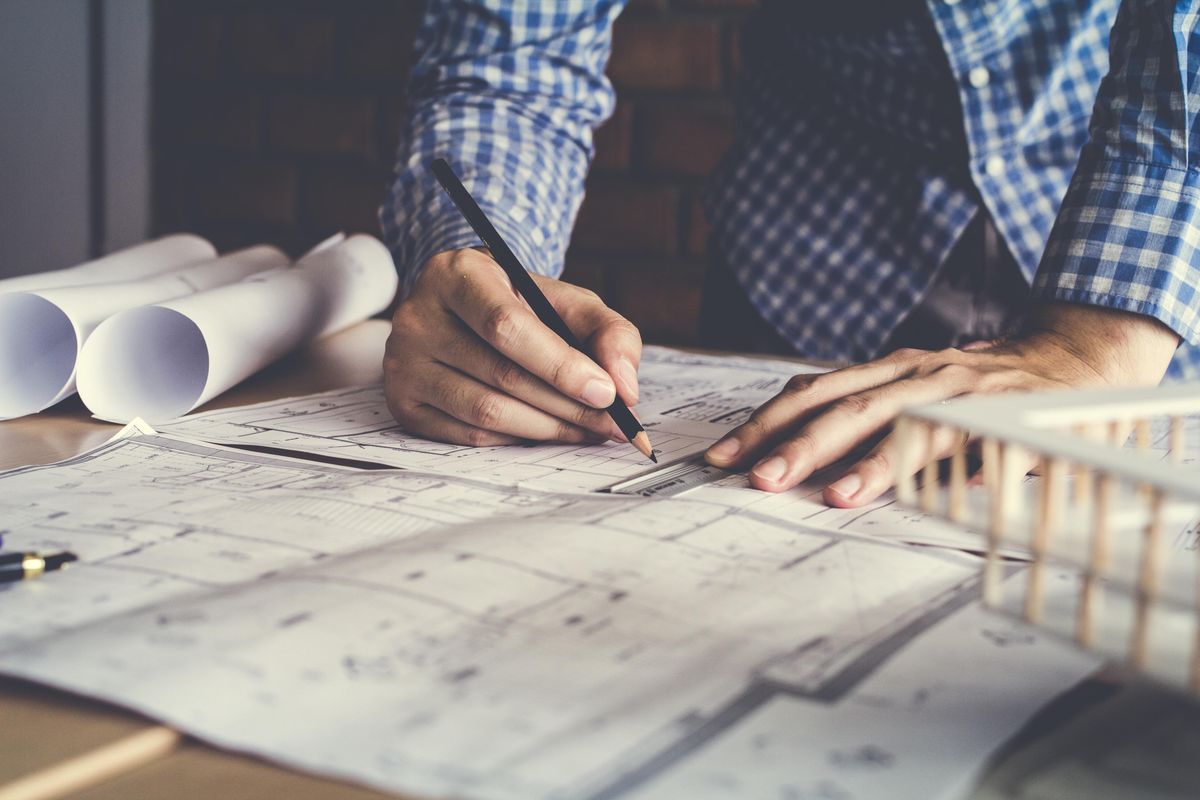 man working on blueprints
