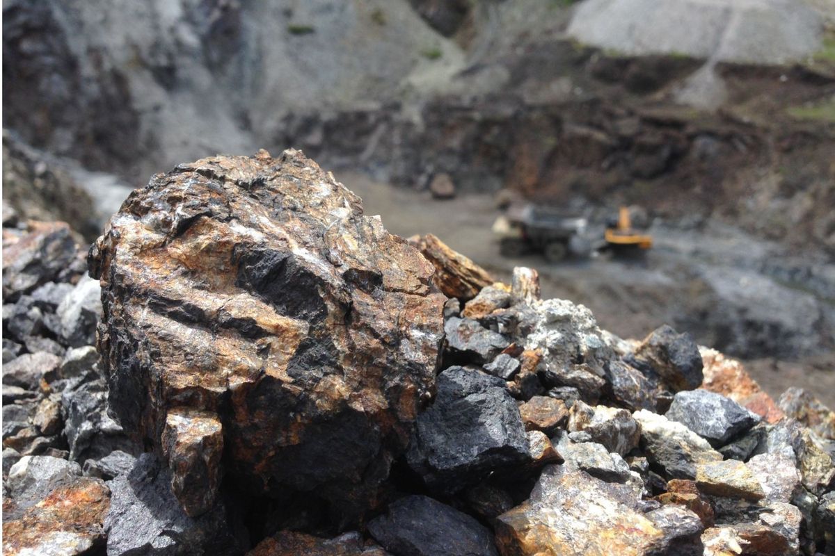 Manganese ore in the foreground at an open-pit manganese mine.