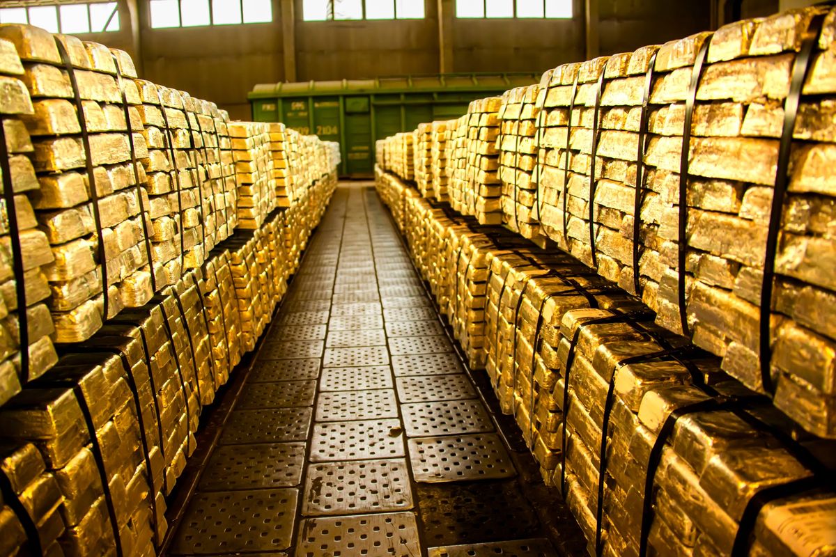 Many large stacks of gold bars. 