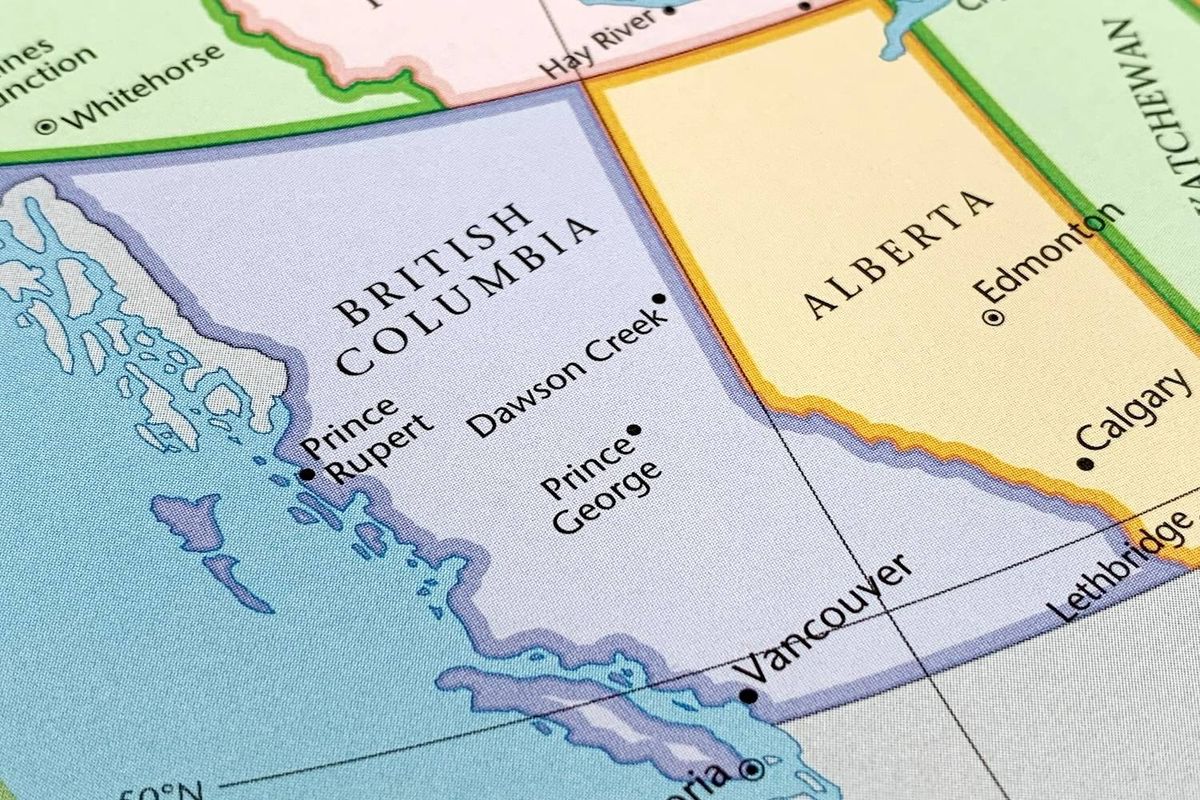 Map detail showing British Columbia and Alberta with cities marked, bordered by blue ocean and green land areas.
