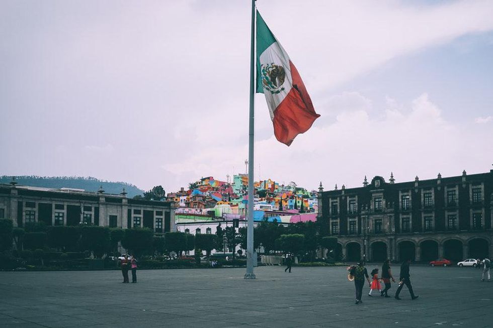 mexican plaza with flag in the middle of the city square
