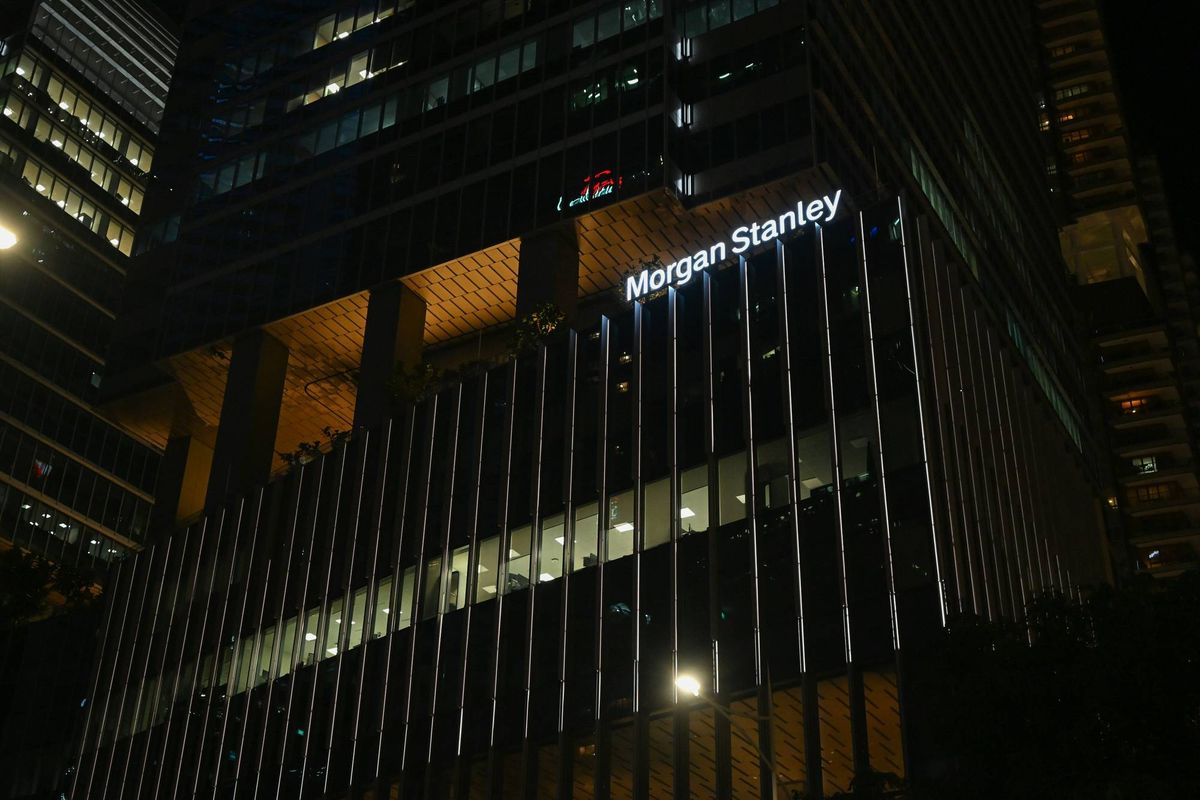 Morgan Stanley building at night, illuminated with vertical lights.
