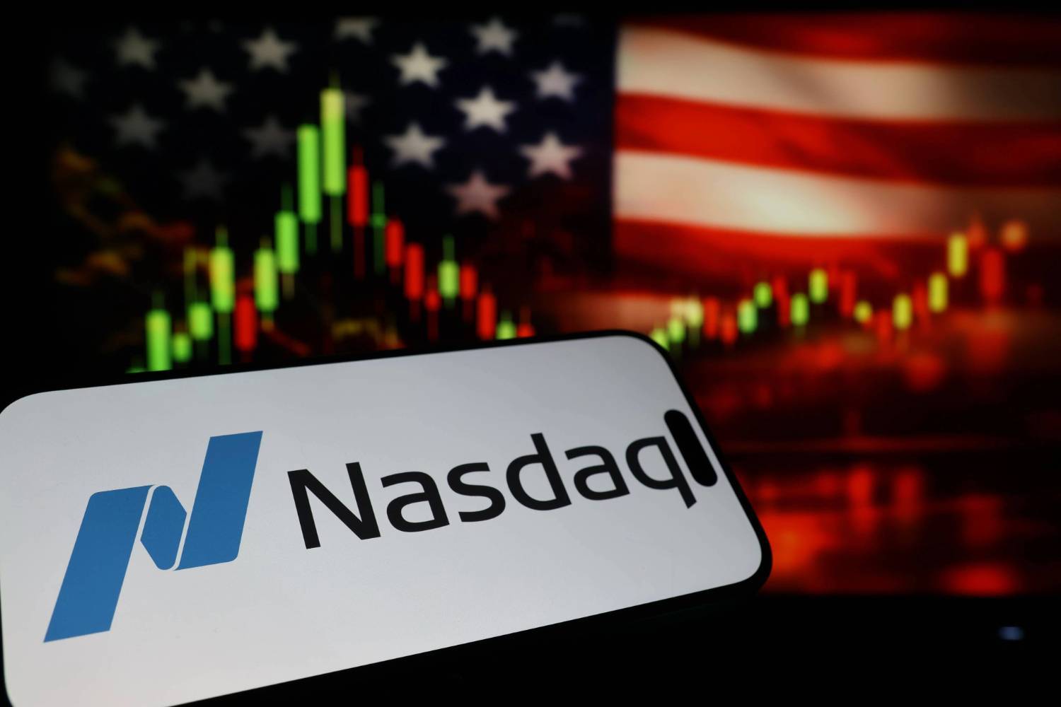 Nasdaq logo over a blurred American flag and stock market graph background.