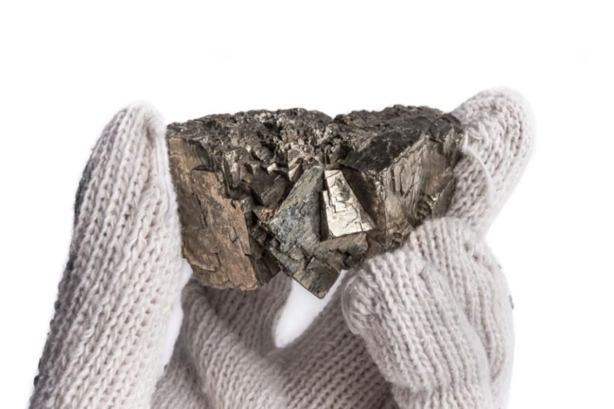 nickel ore in gloved hand