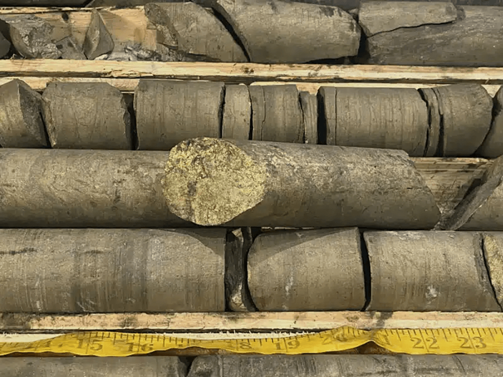Nine Mile Metals' close-up of stacked rock core samples with a measuring tape below.