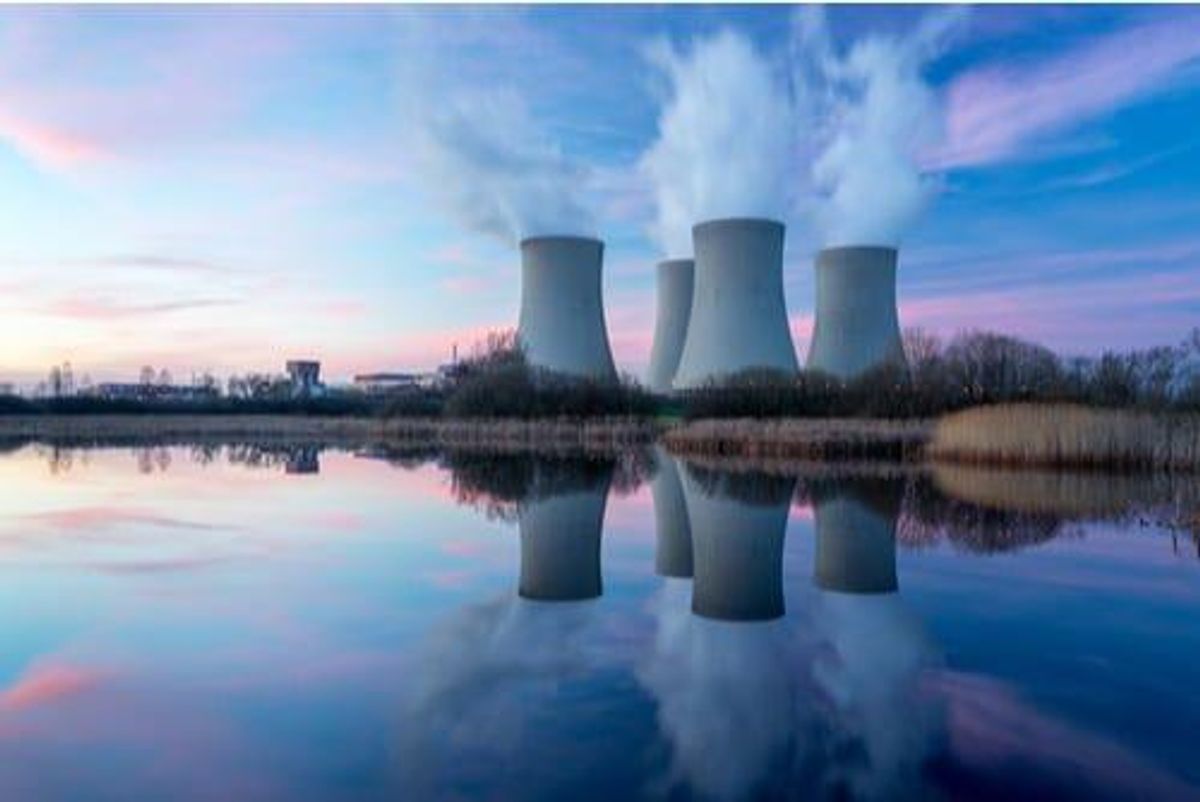 Nuclear reactors reflected on a body of water.