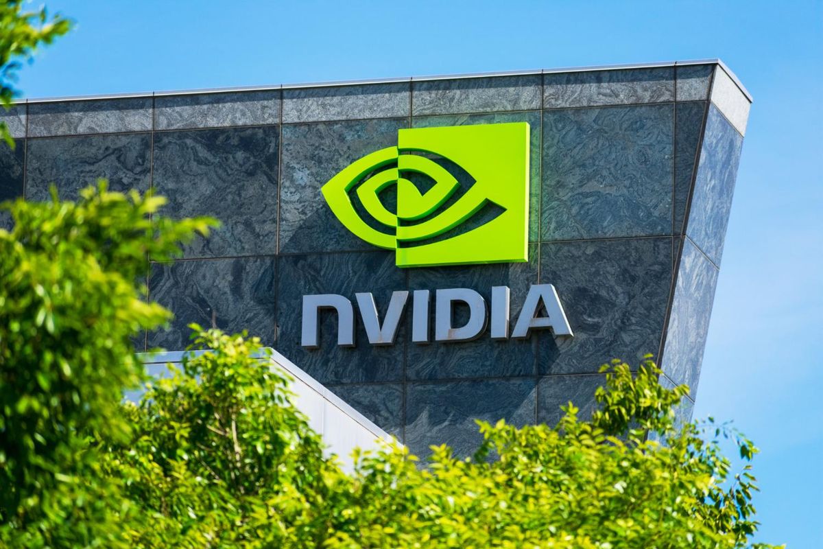 NVIDIA logo on building facade, surrounded by green trees under a clear blue sky.