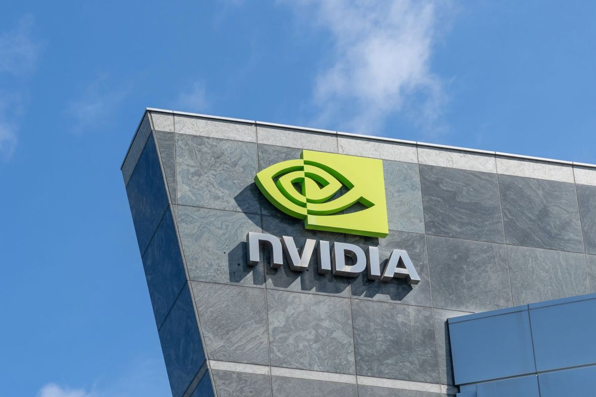 NVIDIA logo on modern building against a clear blue sky.