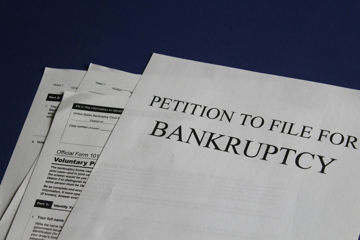 Paper saying "petition to file for bankruptcy." 