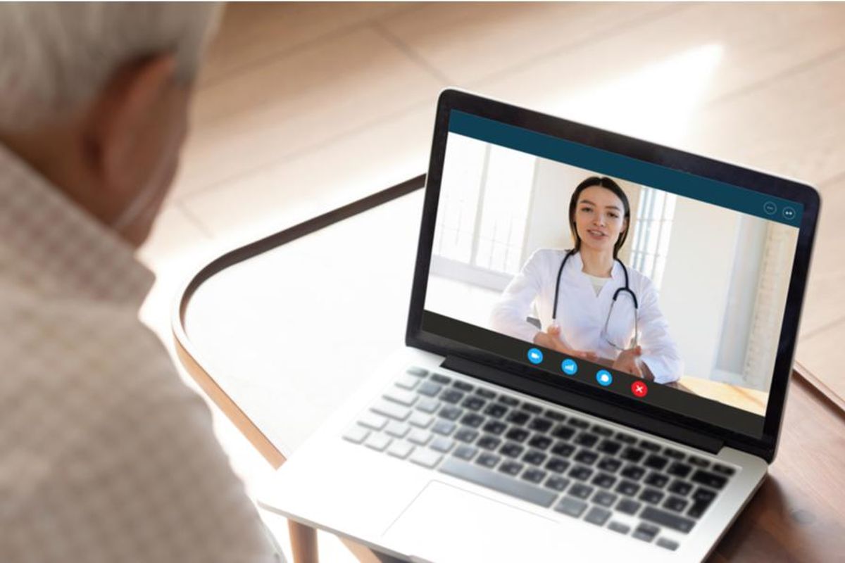 patient holding a visit with their doctor through a computer