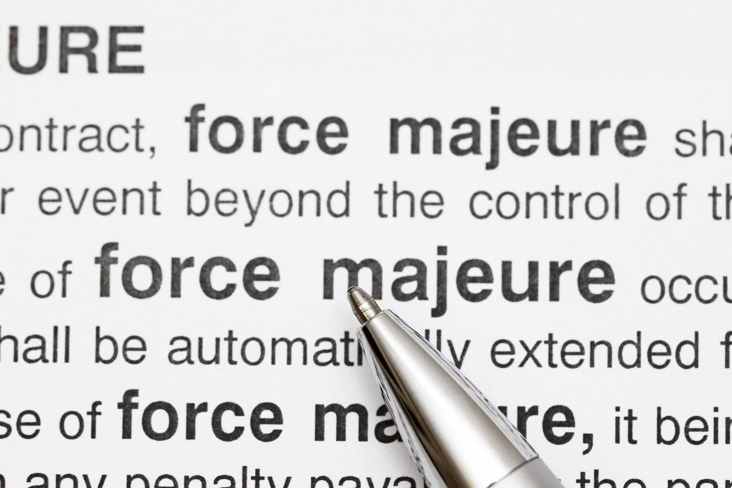 Pen pointing at "force majeure" in a legal document.