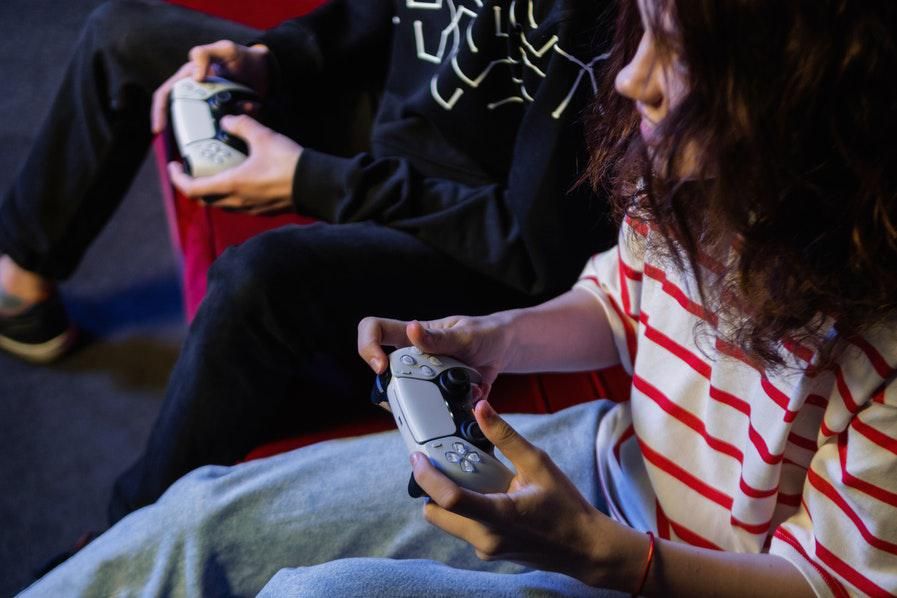 people playing games using ps5 controllers
