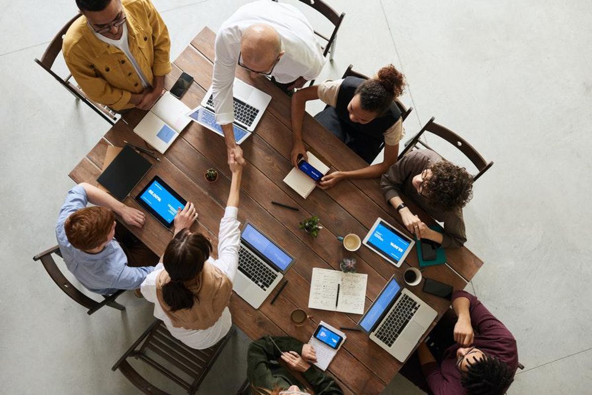 people shaking hands during a business meeting