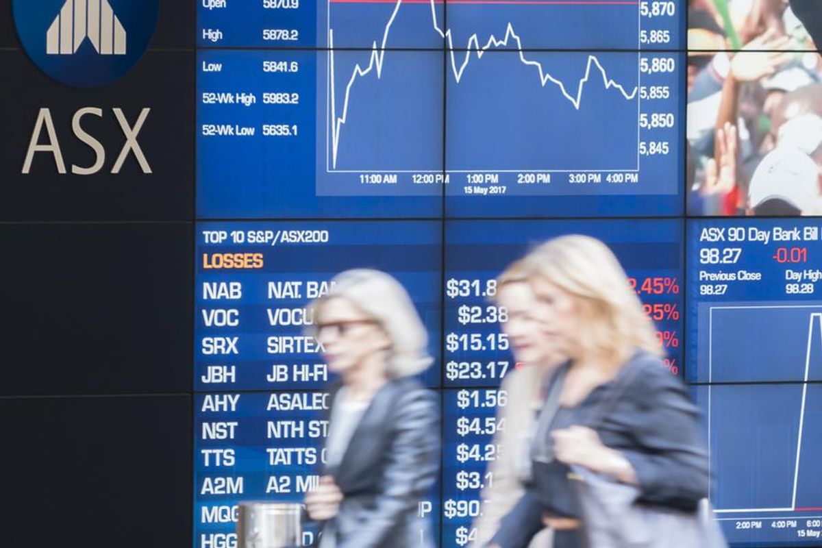 people walking past the display board of the sydney exchange square