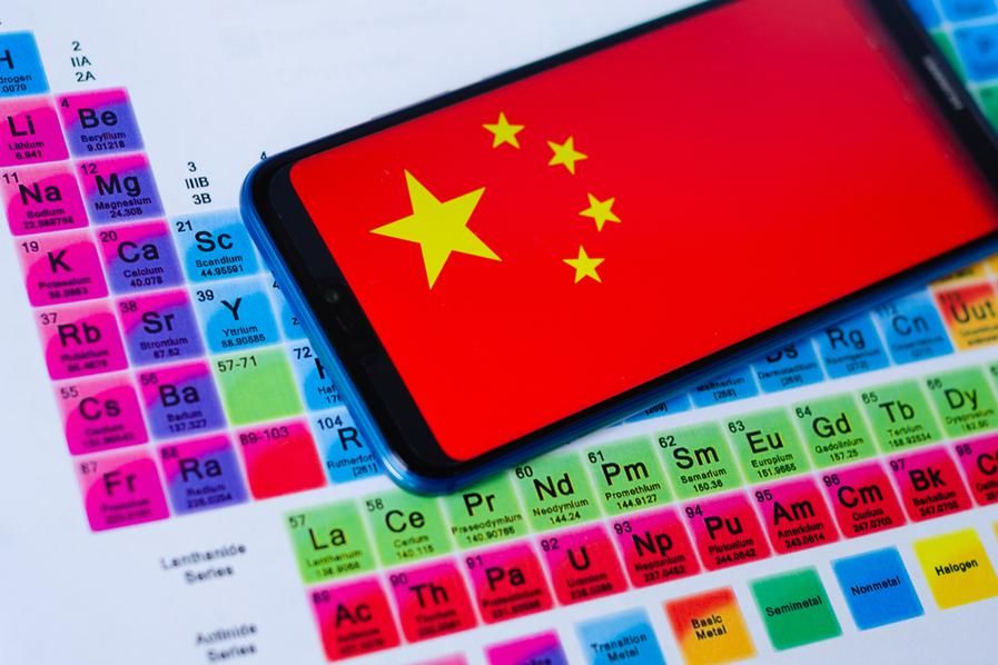 periodic table showing rare earths with cell phone showing chinese flag