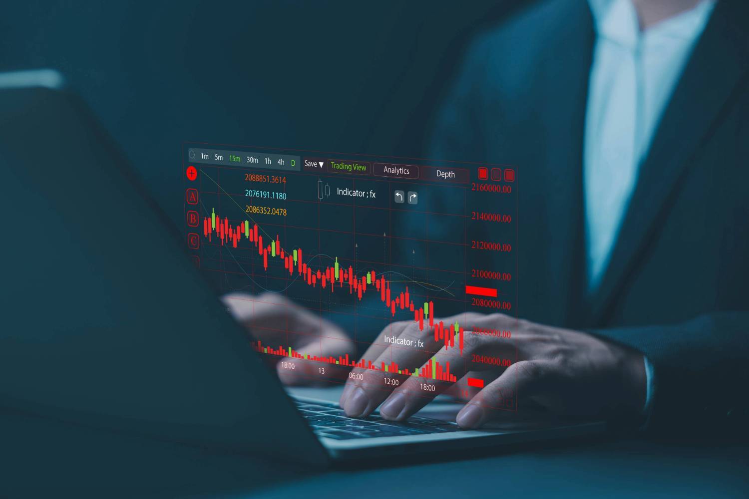 Person analyzing a declining stock chart on a laptop screen.