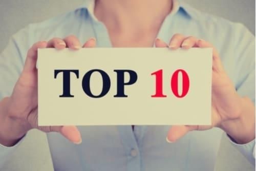 person holding sign that says "Top 10"