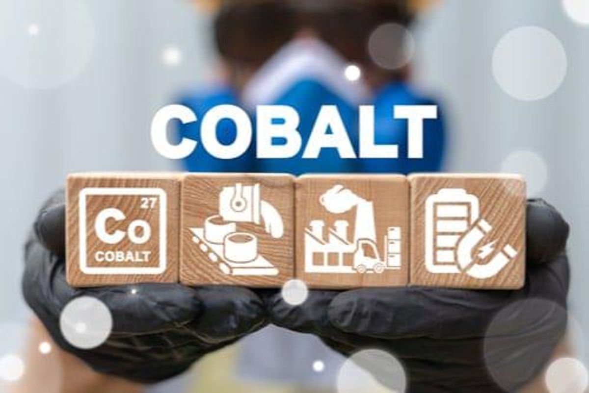 Person in safety equipment holds wooden blocks with cobalt mine symbols and the word "cobalt" above.