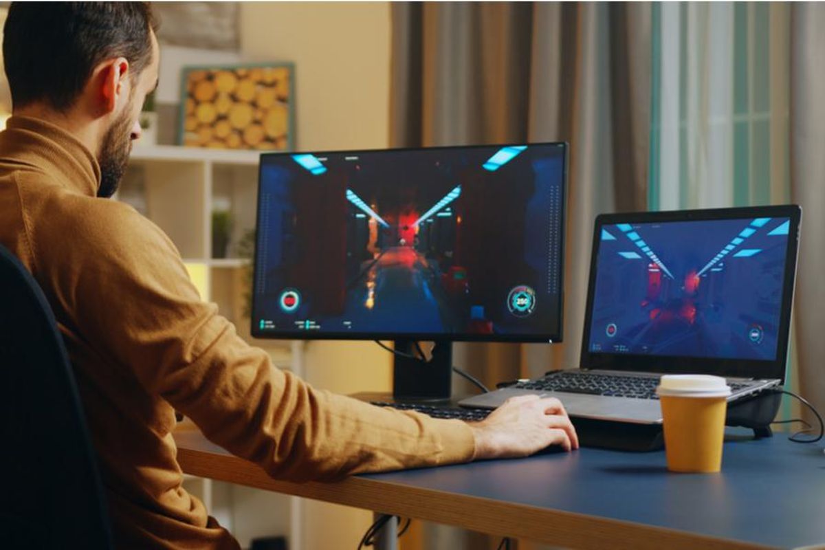 person playing a computer game in their home