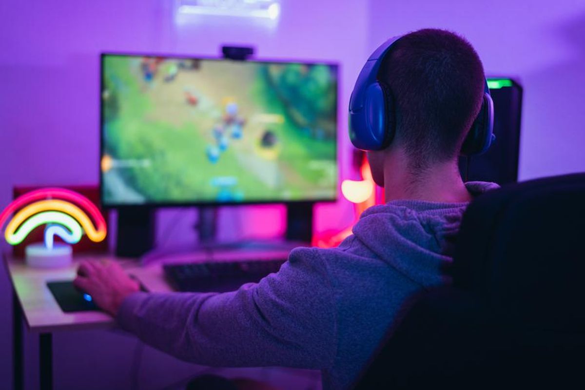 person playing games on a computer with RGB lighting