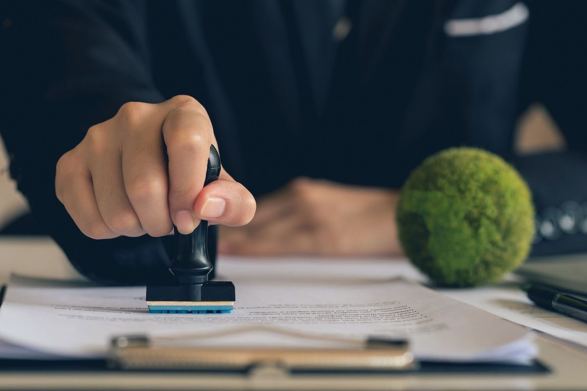 Person stamping a document.