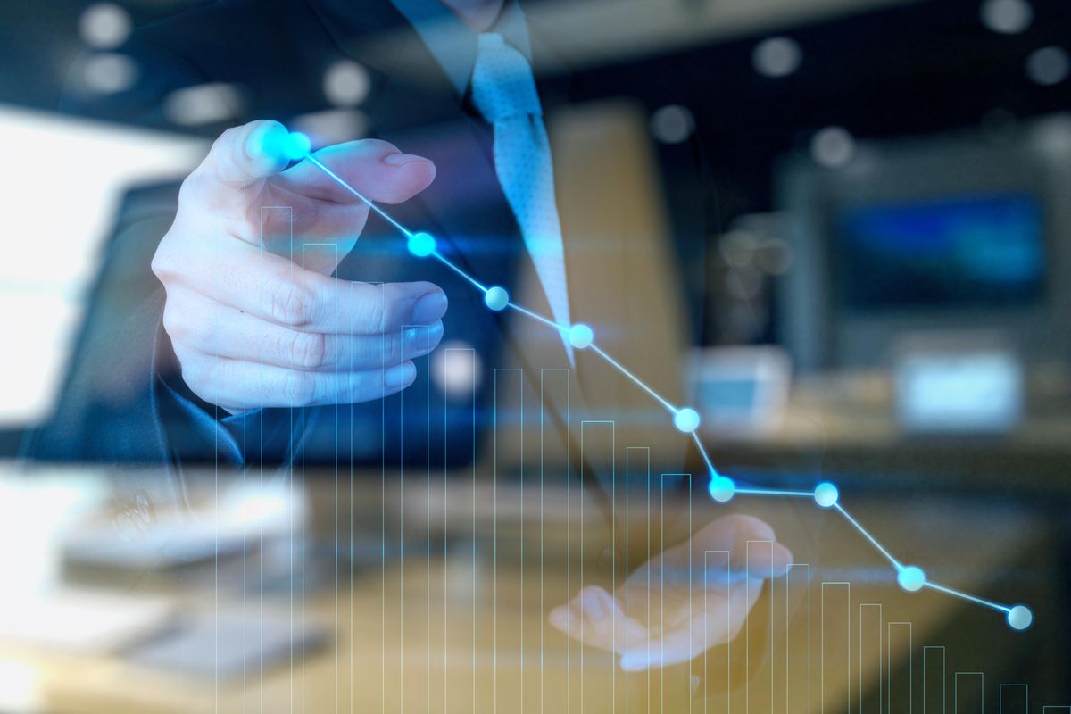 person touching high point on digital representation of rising chart