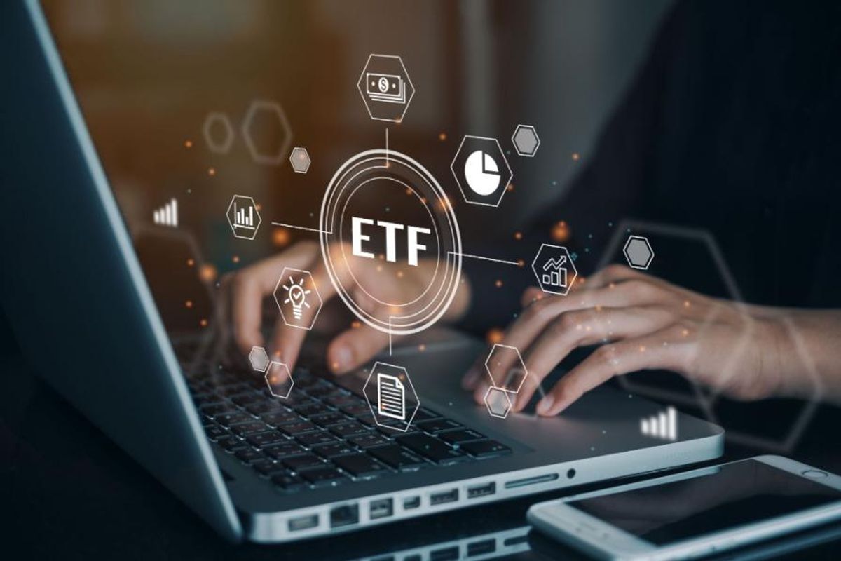 person typing on laptop with etf visual