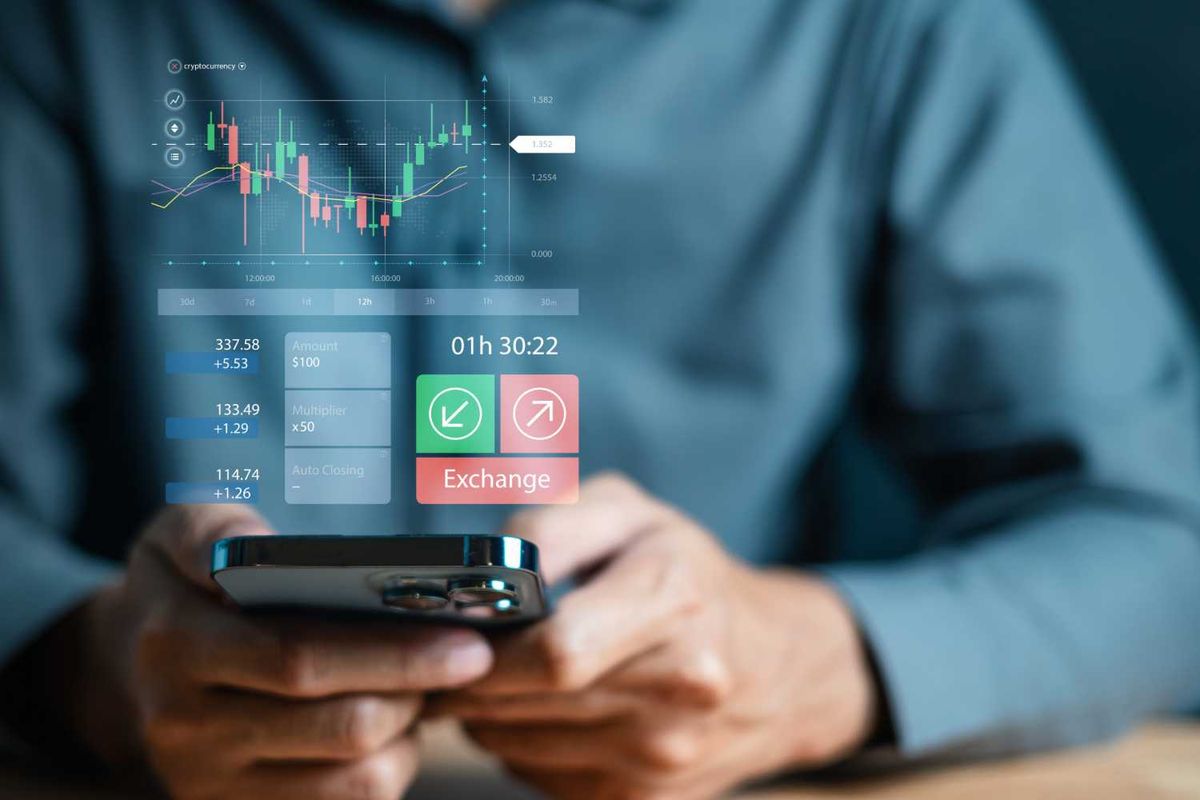 Person using a smartphone displaying cryptocurrency trading graphs and exchange options.