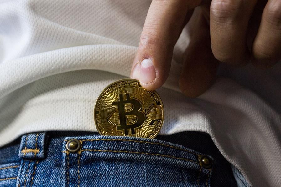 physical token of bitcoin being secured in pocket