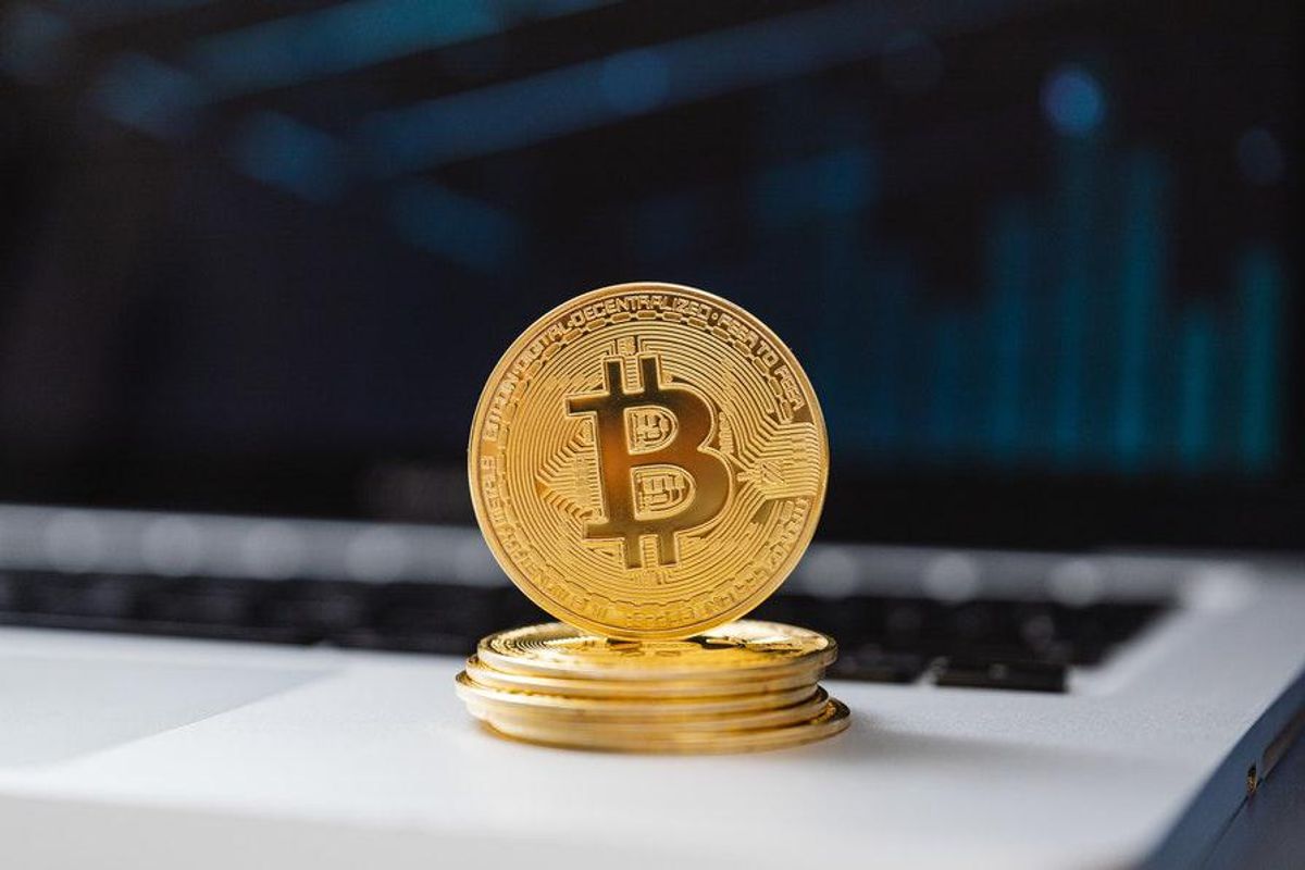 physical token of bitcoin on top of laptop