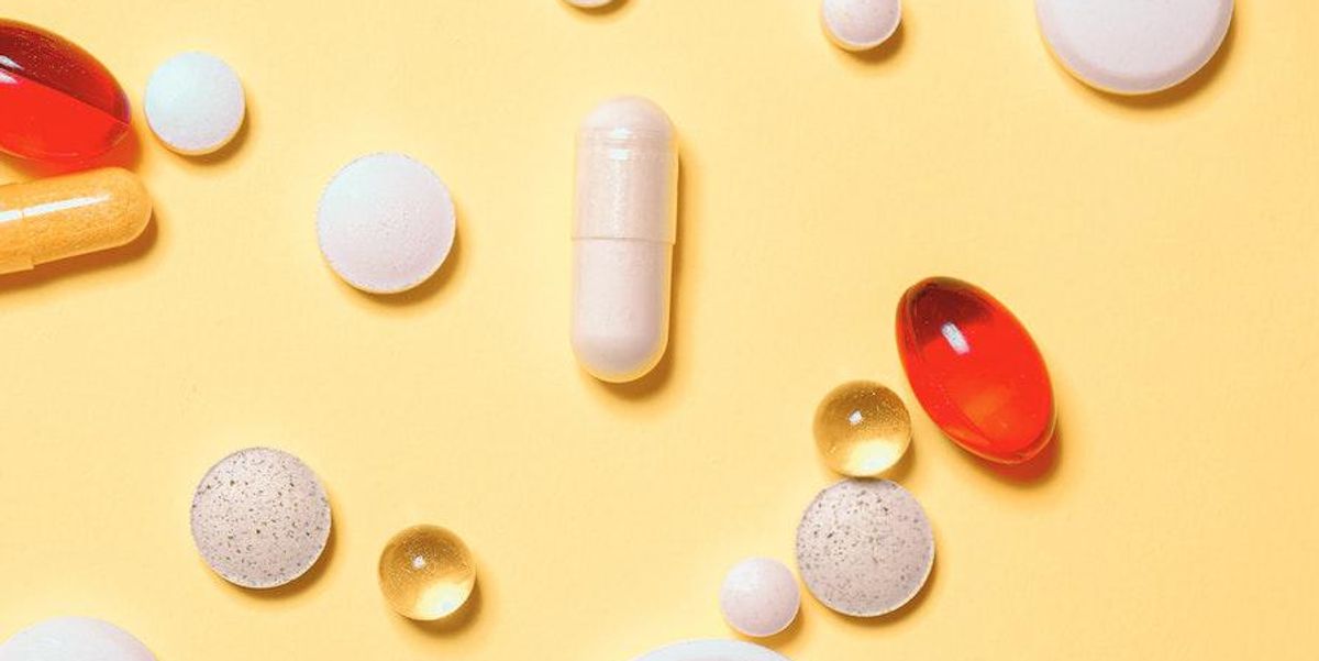 pills sprawled on yellow background