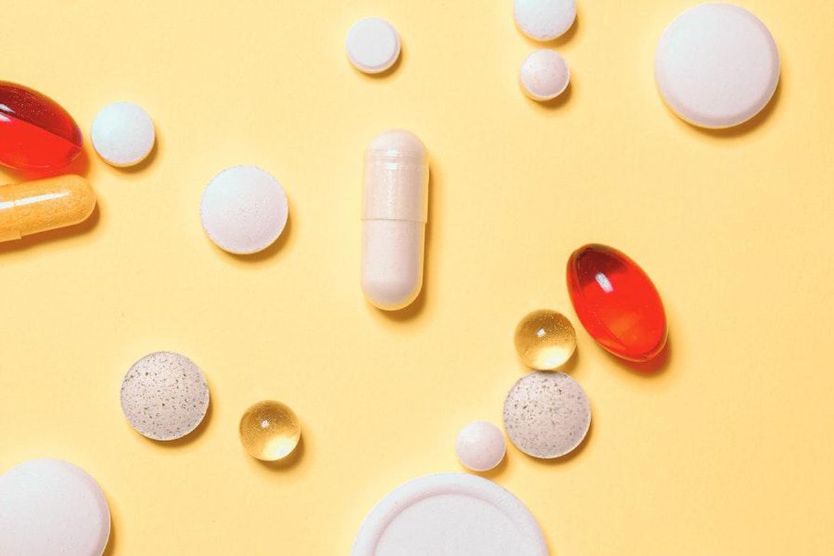 pills sprawled on yellow background