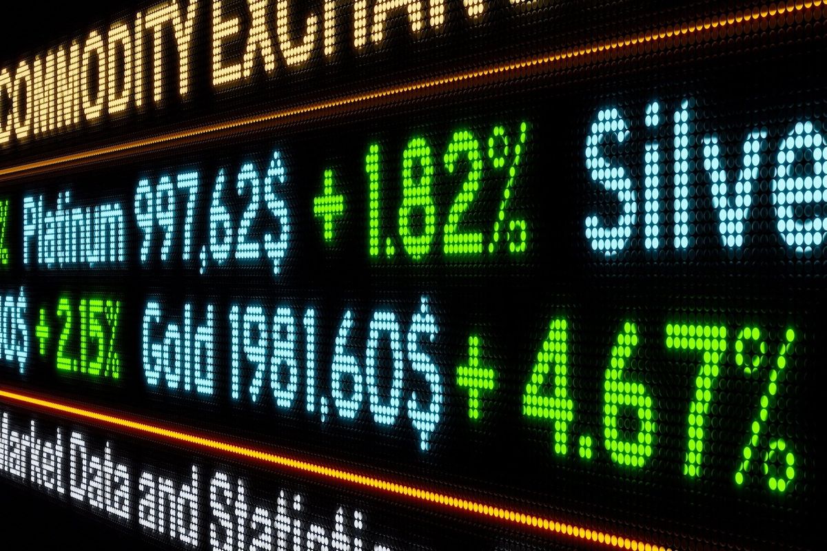 Platinum, silver and gold prices written on board.