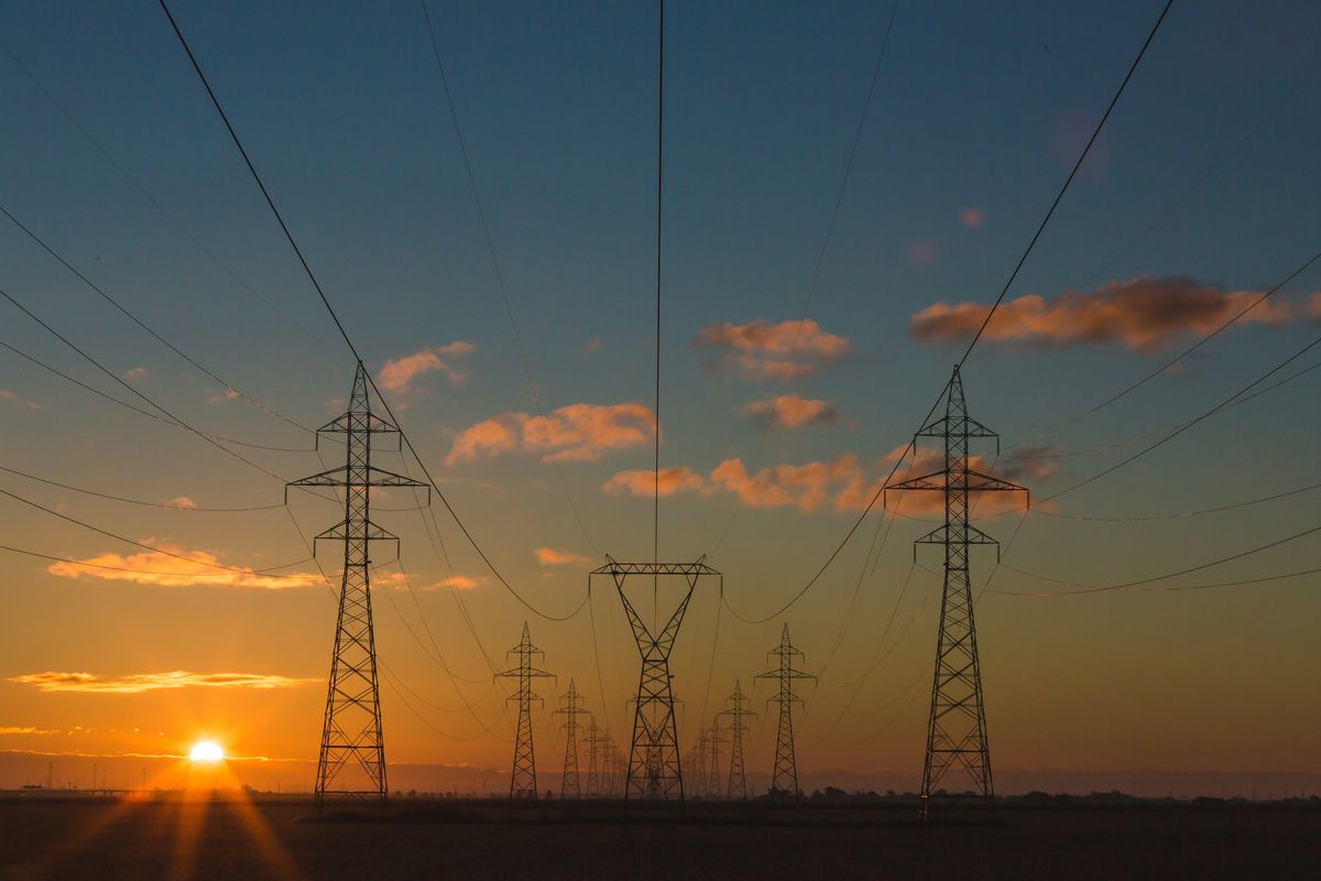 Power lines against sunset.