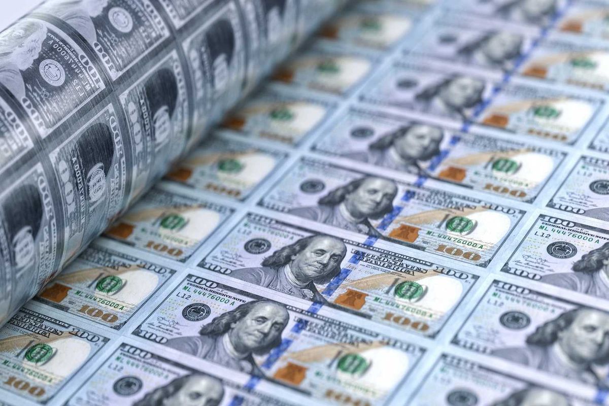 Printing press producing sheets of U.S. hundred-dollar bills.