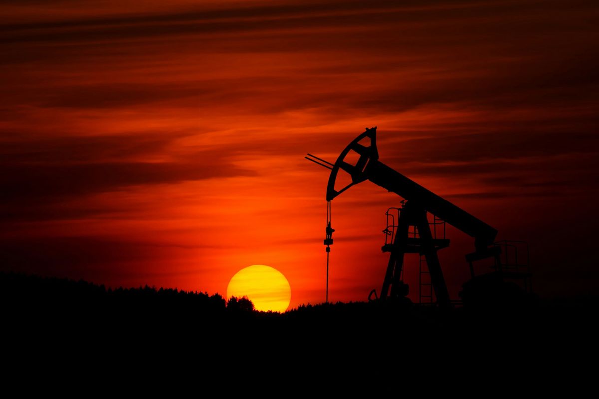 Pumpjack with sun setting.