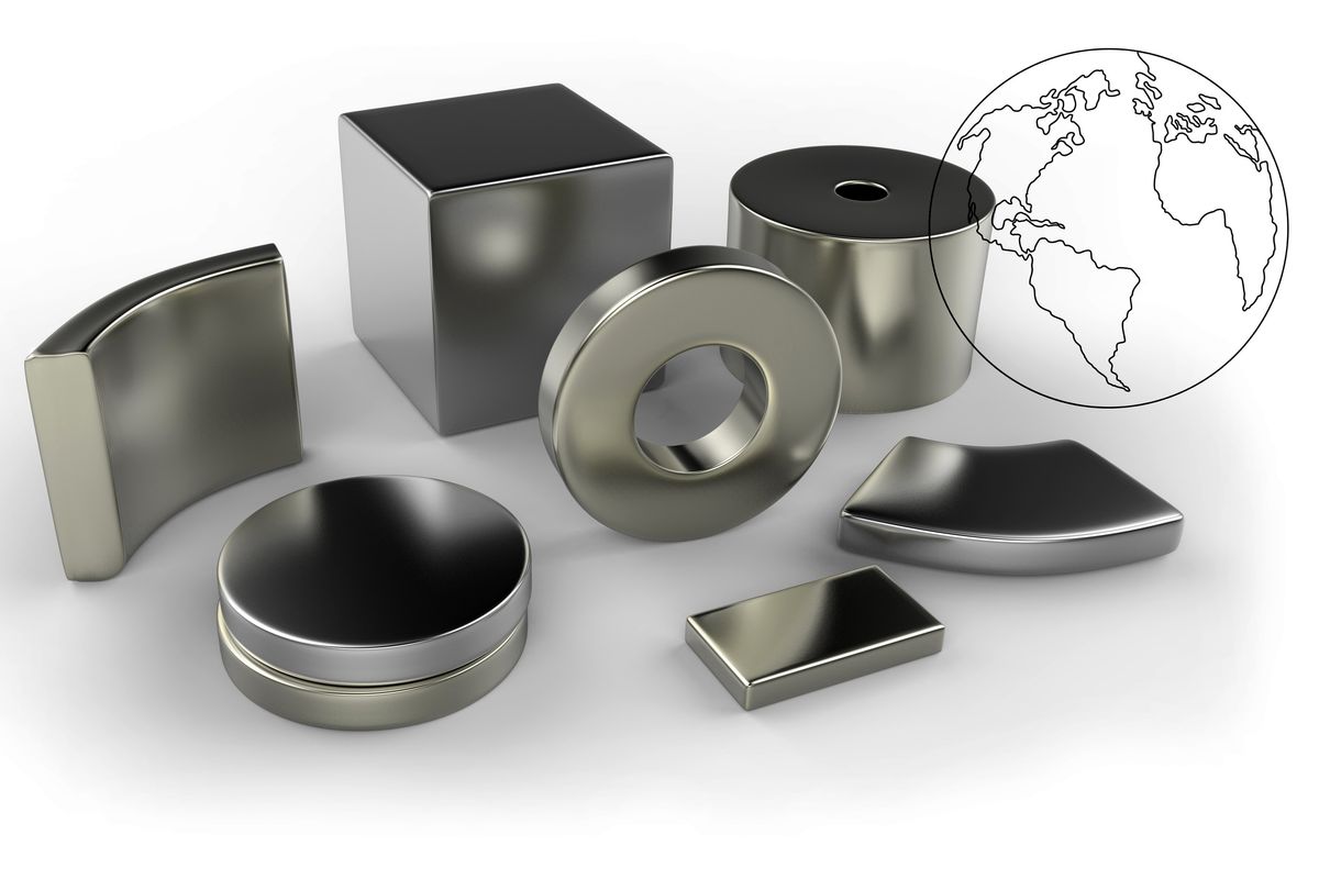 Rare earth magnets with a globe behind them.