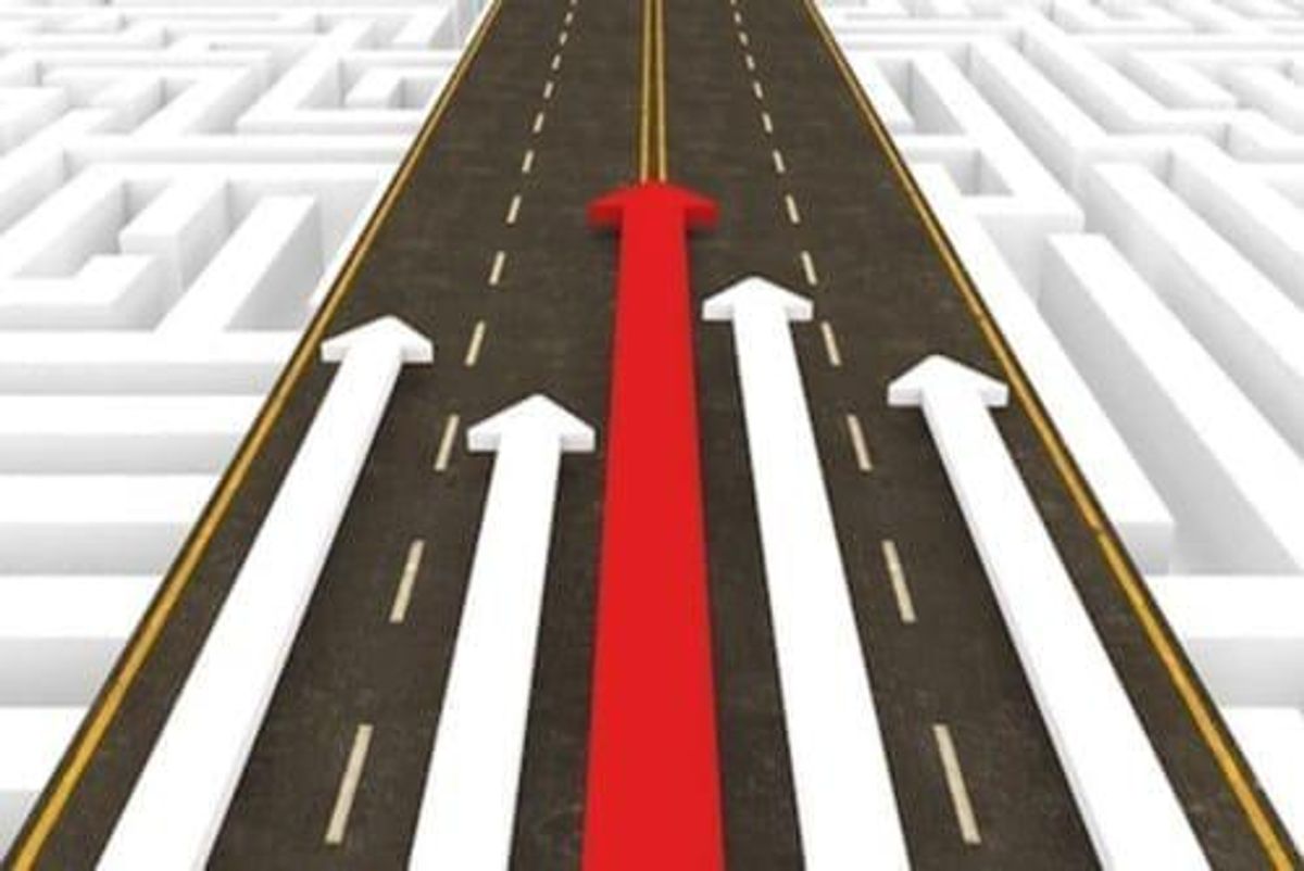 red and white arrows on a road pointing up