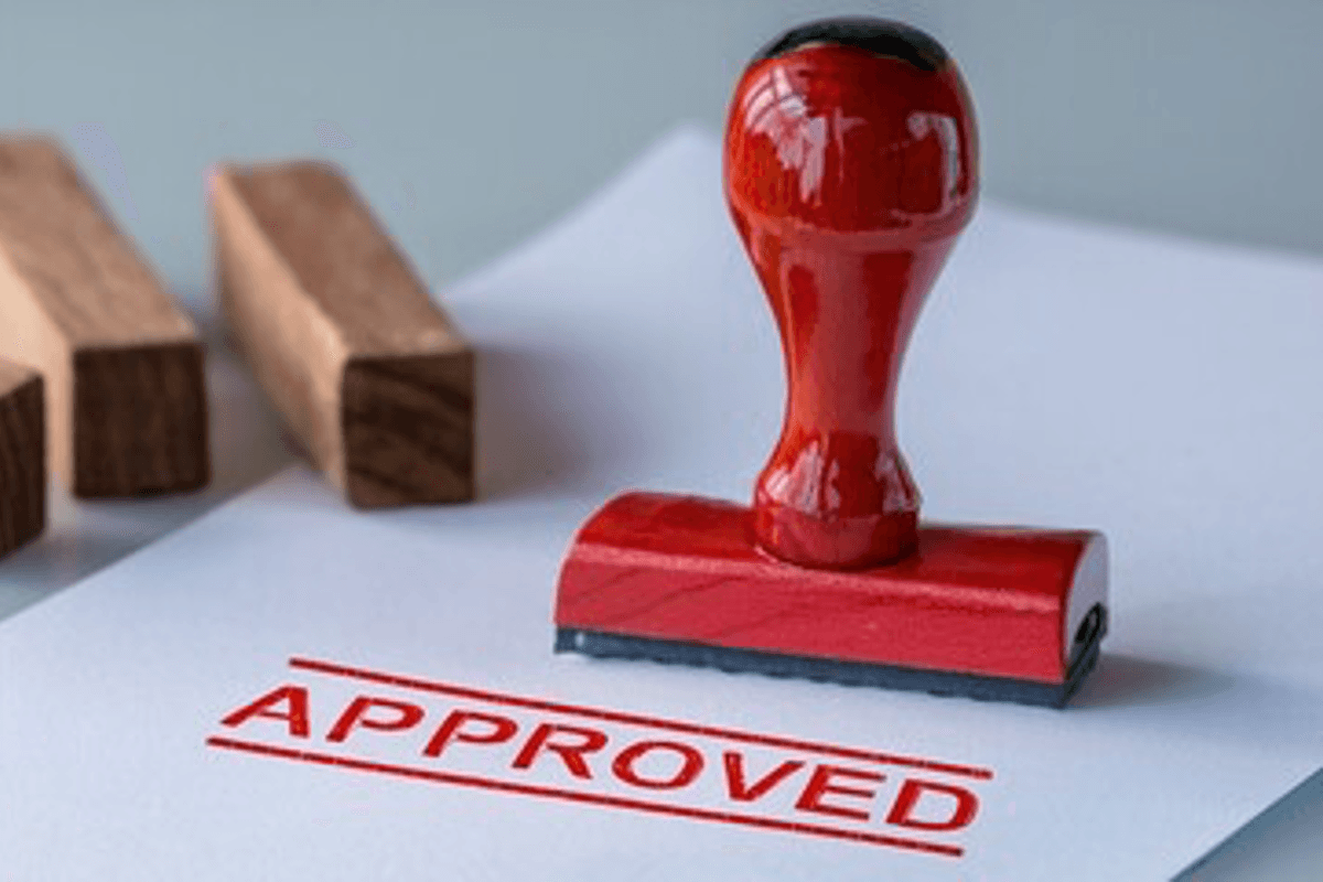 Red stamp on paper with "approved" marked in red.