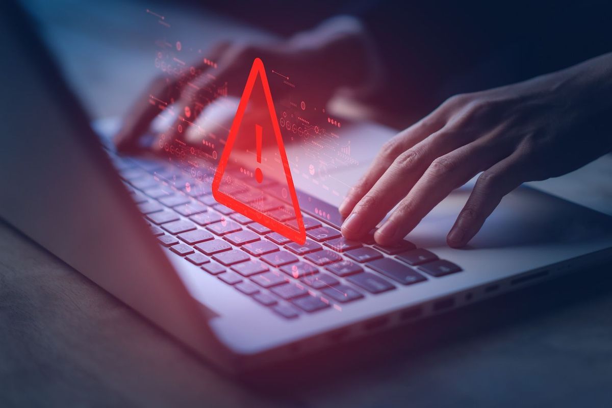 Red threat triangle above laptop keyboard.