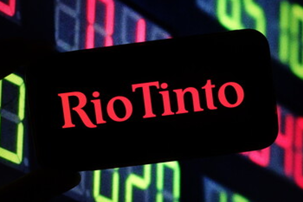 Rio Tinto logo on a dark screen with stock chart background.